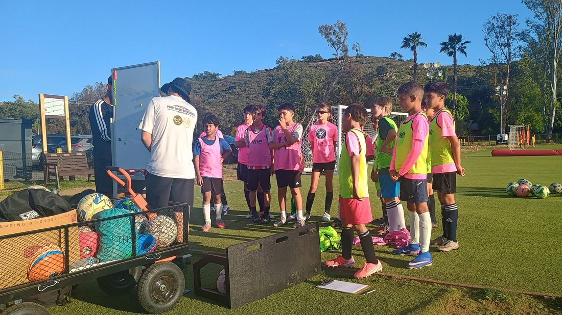 Soro Futbol Academy team huddle at North County Soccer Park